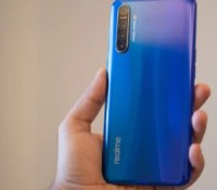 Realme-XT-in-hand-with-back-panel-and-gradient