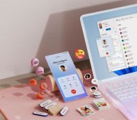 msft-open-laptop-with-mobile-phone-floating-emojis-RW10WBx