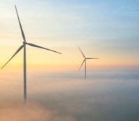 Wind turbines seen from the air during a beautiful and colorful morning with mist and sun. 
Muntendam, Groningen, the Netherlands, Oktober 2024