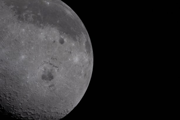 art002e009278 (April 6, 2026) - Just over half of the Moon fills the left half of the image. The near side, characterized by the dark patches of ancient lava, is visible on the top third of the lunar disk. Orientale basin, a round crater in the center with a black patch of ancient lava in the center, is wrapped in rings of mountains. The round black spot northeast of Orientale is Grimaldi crater, and Aristarchus crater is the bright white dot in the midst of a dark grey lava flow at the top of the image.