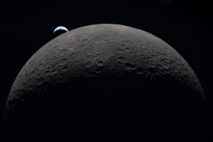 art002e009287 (April 6, 2026) &ndash; Earth sets at 6:41 p.m. EDT, April 6, 2026, over the Moon&rsquo;s curved limb in this photo captured by the Artemis II crew during their journey around the far side of the Moon. Orientale basin is perched on the edge of the visible lunar surface. Hertzsprung Basin appears as two subtle concentric rings, which are interrupted by Vavilov, a younger crater superimposed over the older structure. The lines of indentations are secondary crater chains formed by ejecta from the massive impact that created Orientale.
The dark portion of Earth is experiencing nighttime. On Earth&rsquo;s day side, swirling clouds are visible over the Australia and Oceania region.