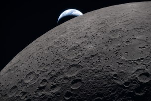 art002e009289 (April 6, 2026) &ndash; The lunar surface fills the frame in sharp detail, as seen during the Artemis II lunar flyby, while a distant Earth sets in the background. This image was captured at 6:41 p.m. EDT, on April 6, 2026, just three minutes before the Orion spacecraft and its crew went behind the Moon and lost contact with Earth for 40 minutes before emerging on the other side.
In this image, the dark portion of Earth is experiencing nighttime, while on its day side, swirling clouds are visible over the Australia and Oceania region. In the foreground, Ohm crater shows terraced edges and a relatively flat floor marked by central peaks &mdash; formed when the surface rebounded upward during the impact that created the crater.