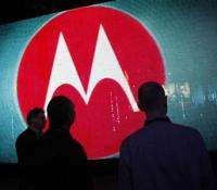 Visitors look at a video display at the Motorola booth on the second day of the Consumer Electronics Show (CES) in Las Vegas