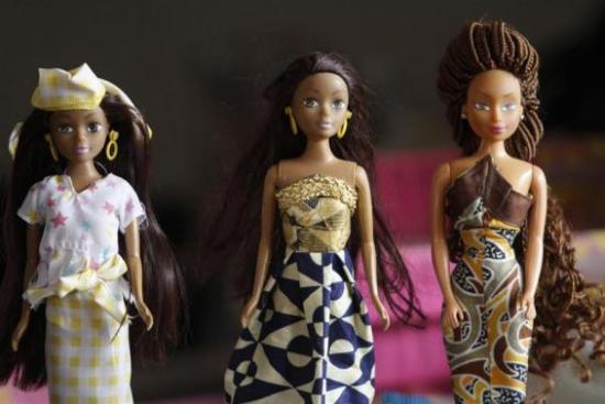 Dolls dressed in local attire are arranged on a table at a workshop in Surulere district, in Nigeria's commercial capital Lagos