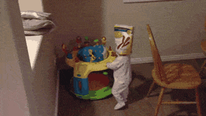 Toddler wearing a cereal box - compress Toddler wearing a cereal box - compress