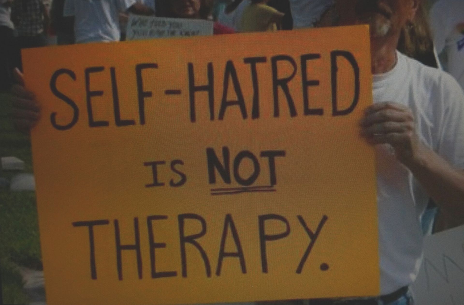Panneau disant « La haine de soi n'est pas une thérapie ».
