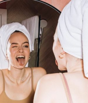 Une femme grimaçant devant son miroir