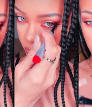 la chanteuse Rihanna appliquant de l'eye-liner rouge