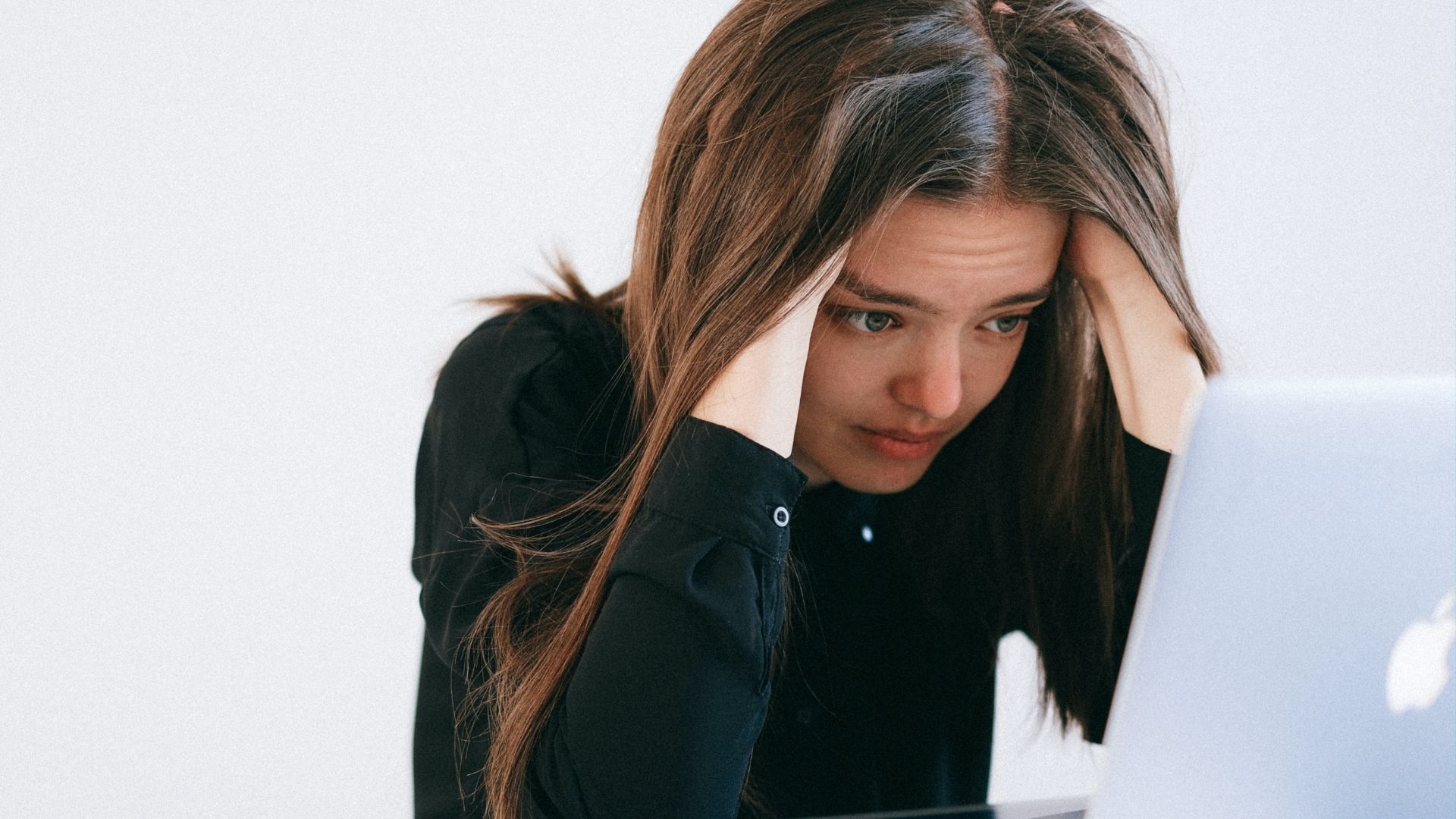 Femme accablée devant son ordinateur