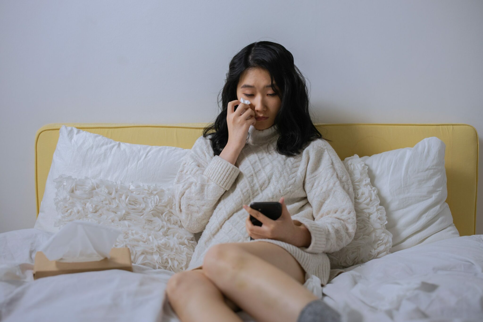 Femme pleurant devant son smartphone Femme pleurant devant son smartphone