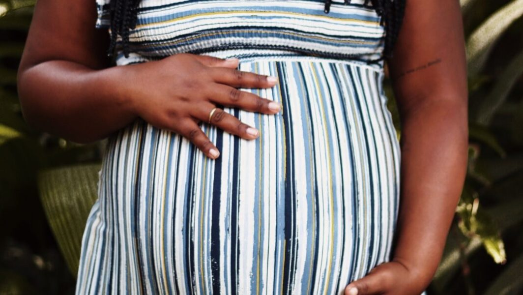 femme enceinte avec une main sur son ventre