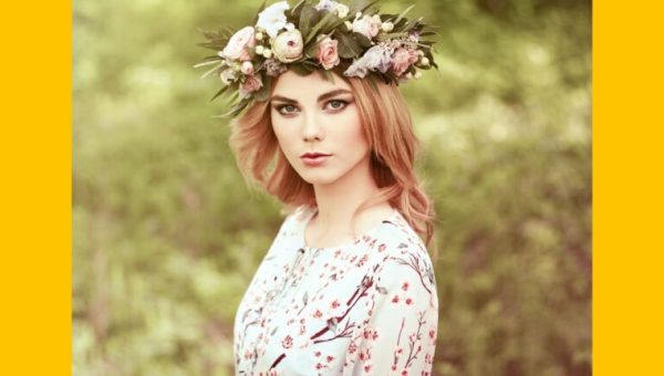 Une femme portant une couronne de fleurs au milieu d’un champ d’herbe, Oleg Gekman via Canva