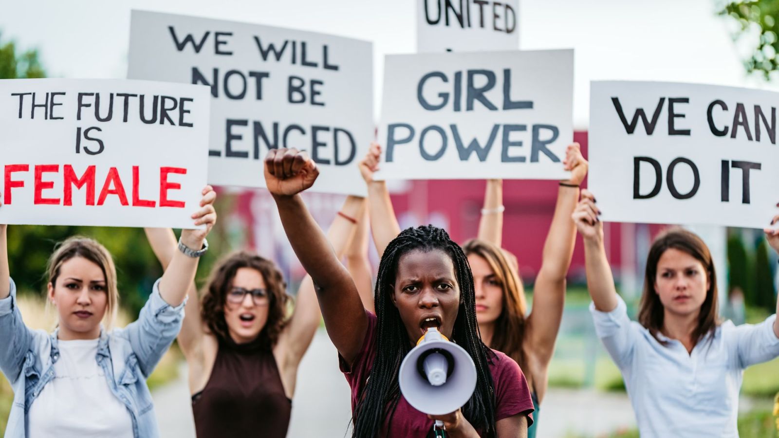 A photo of women protesting against sexism, symbolizing the struggles women, including Jackie Chan's daughter and wife, may face in their personal and professional lives.