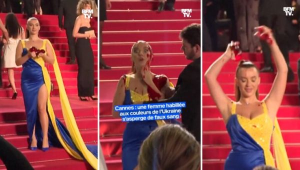 Une femme dans une robe aux couleurs du drapeau de l'Ukraine se recouvre de faux sang sur le tapis rouge du festival de Cannes 2023 // Source : Capture d'écran Twitter de BFM TV