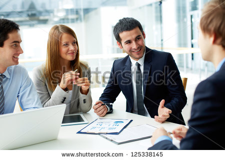 stock-photo-image-of-business-partners-discussing-documents-and-ideas-at-meeting-125338145