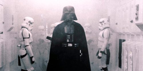 In this 1977 image provided by 20th Century-Fox Film Corporation, Darth Vader, played by David Prowse and voiced by James Earl Jones, and his Imperial stormtroopers take over the Rebel Blockade Runner in a scene from 