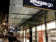 People walk by the Amazon Go brick-and-mortar grocery store without lines or checkout counters, in Seattle Washington