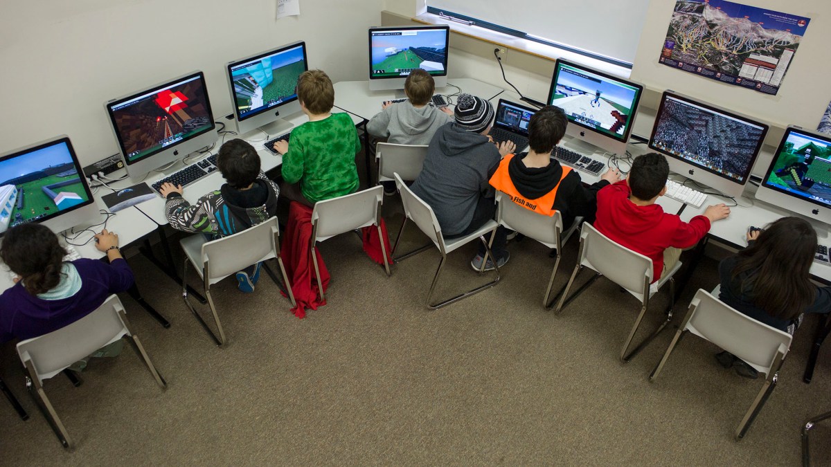 Sixth-graders at Dzantik'i Heeni Middle School work on the Mindcraft mazes during their technology class in Juneau, Alaska, on Friday, March 6, 2015.  Rather than fight the electronic glue, some educators are embracing children tech-obsession and finding ways to incorporate computer games into the classroom. None has been more popular than Minecraft. (AP Photo/The Juneau Empire, Michael Penn )