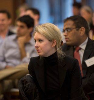 Elizabeth Holmes, the chief executive officer and founder of Theranos, a health care technology company, listens as Deputy Secretary of Defense Ash Carter speaks at Stanford University in Palo Alto, Calif., April 17, 2013. (DoD photo by Glenn Fawcett/Released)