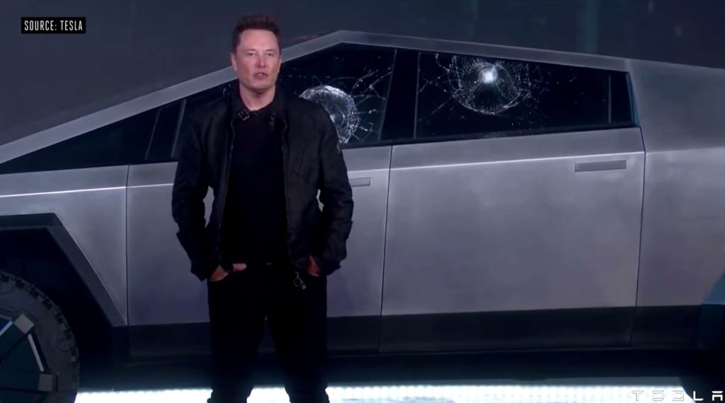 Elon Musk in front of the broken windows of his CyberTruck // Source: YouTube/Tesla/TheVerge