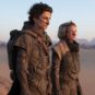 Paul and Lady Jessica carrying the distills in the Arrakis desert.  // Source: Warner