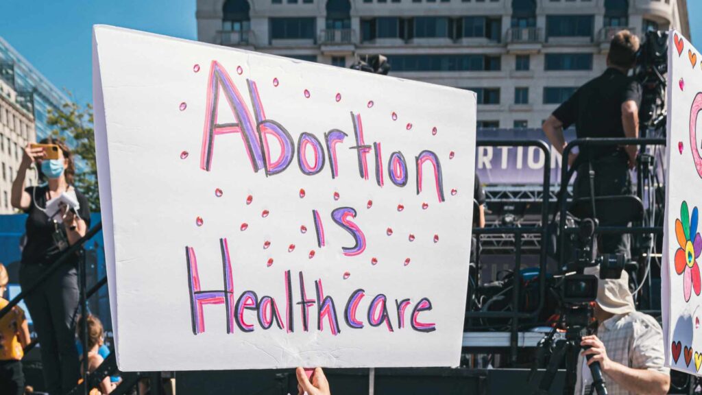 Une pancarte pendant une manifestation en soutien au droit à l'IVG, qui dit « l'avortement fait partie des soins de santé » // Source : Gayatri Malhotra / Unsplash