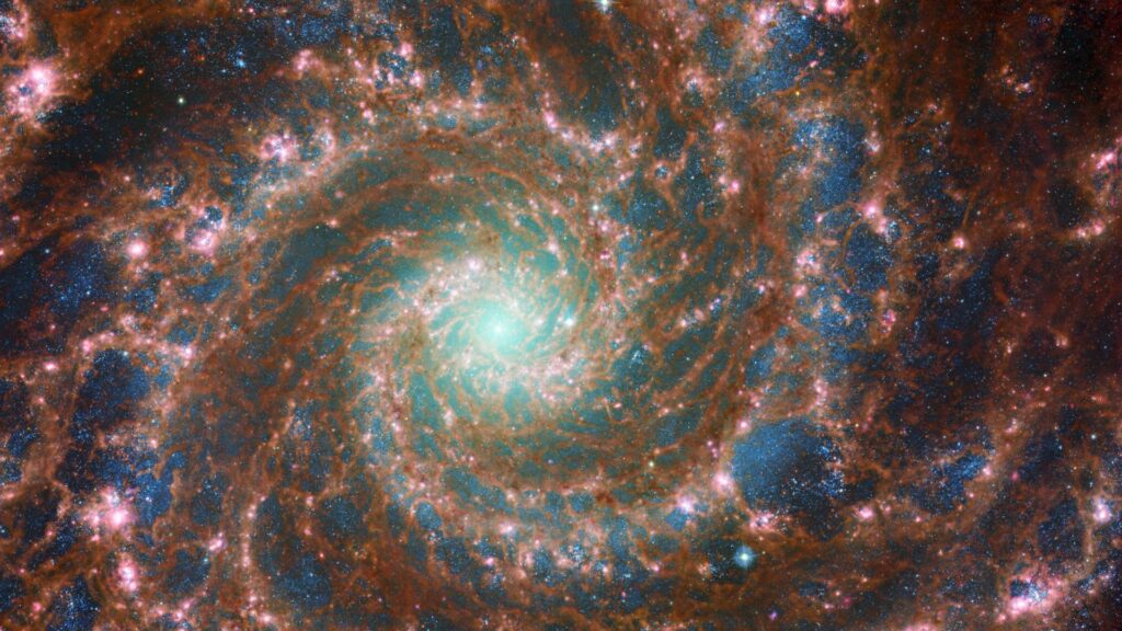 La galaxie M74 à travers le spectre, en combinant Hubble et James Webb. // Source : ESA