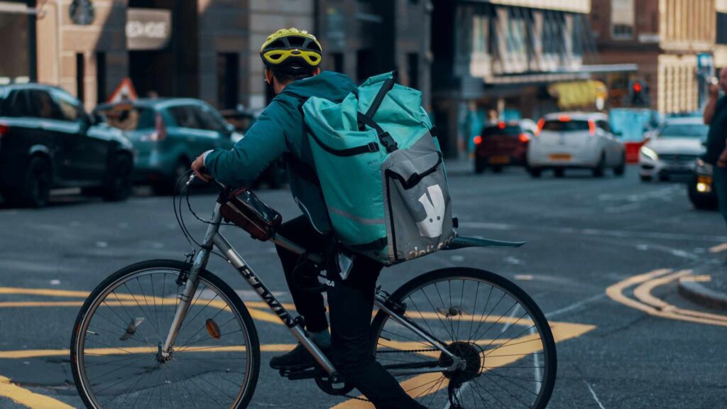 A Deliveroo delivery man // Source: Unsplash / Ross Sneddon