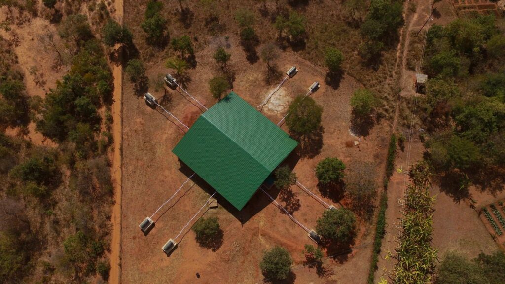 The giant mosquito cage and the tents.  // Source: Via Twitter @McMenimanLab