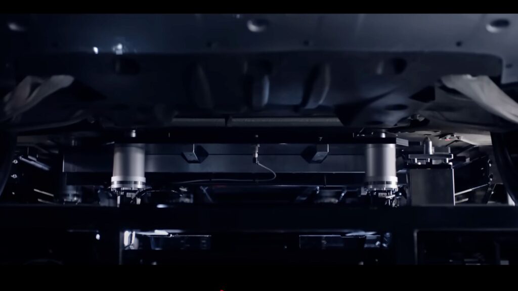 Des bras robots viennent sous la voiture récupérer la batterie // Source : Nio Des bras robots viennent sous la voiture récupérer la batterie // Source : Nio