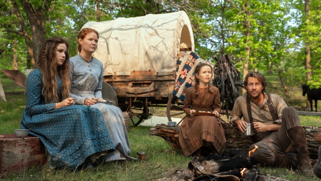 Little House on the Prairie. (L to R) Skywalker Hughes as Mary Ingalls, Crosby Fitzgerald as Caroline Ingalls, Alice Halsey as Laura Ingalls, Luke Bracey as Charles Ingalls in episode 101 of Little House on the Prairie. Cr. Eric Zachanowich/Netflix © 2026 Little House on the Prairie. (L to R) Skywalker Hughes as Mary Ingalls, Crosby Fitzgerald as Caroline Ingalls, Alice Halsey as Laura Ingalls, Luke Bracey as Charles Ingalls in episode 101 of Little House on the Prairie. Cr. Eric Zachanowich/Netflix © 2026